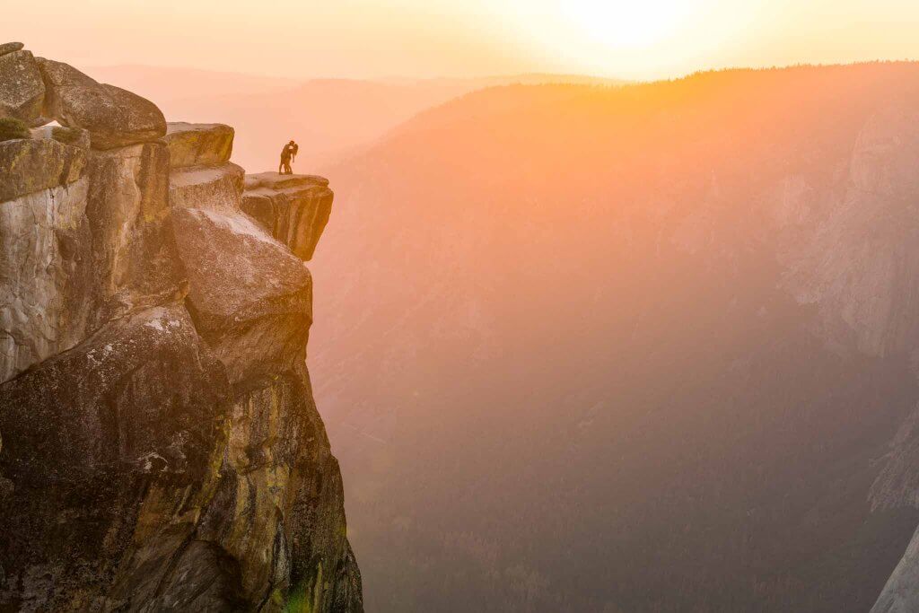 golden hour taft point in yosemite national park a couple kissing engagement shoot