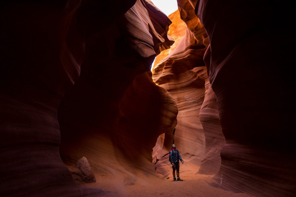 hiker walking through lower antelope canyon