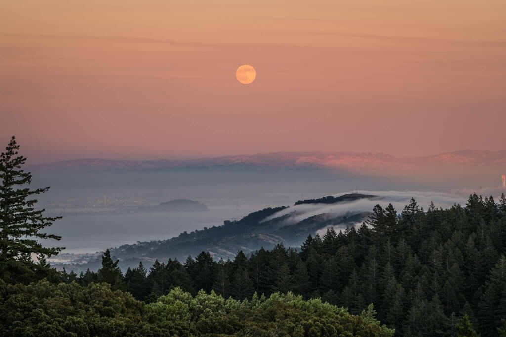 sunset moon rise rolling fog in san francisco northern california